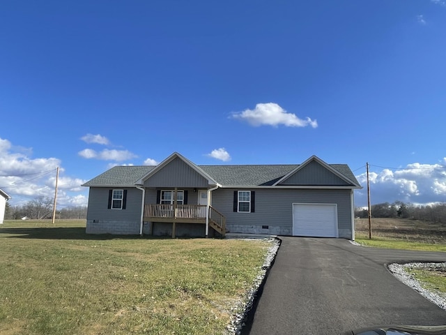 ranch-style home with aphalt driveway, an attached garage, covered porch, a shingled roof, and a front lawn