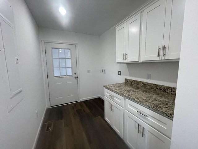 laundry area featuring washer hookup, dark wood finished floors, cabinet space, hookup for an electric dryer, and baseboards