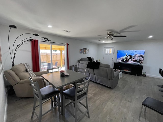 dining space featuring baseboards, visible vents, a ceiling fan, wood finished floors, and recessed lighting