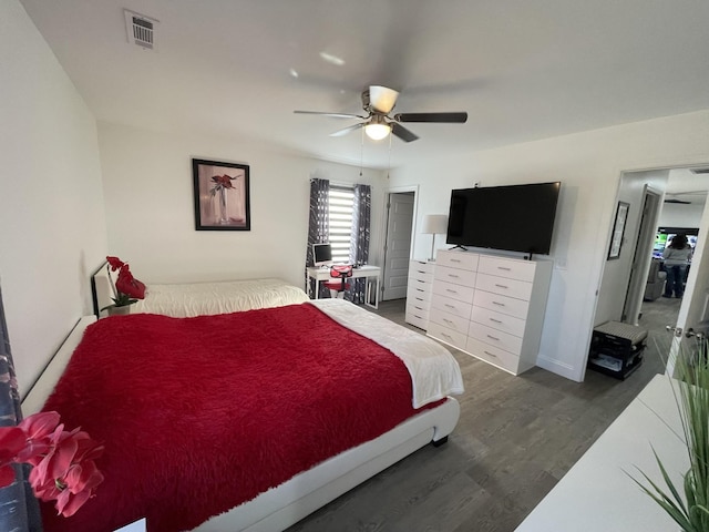 bedroom featuring ceiling fan, dark wood finished floors, and visible vents