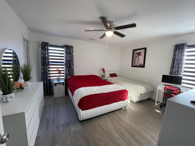 bedroom featuring ceiling fan and dark wood-type flooring