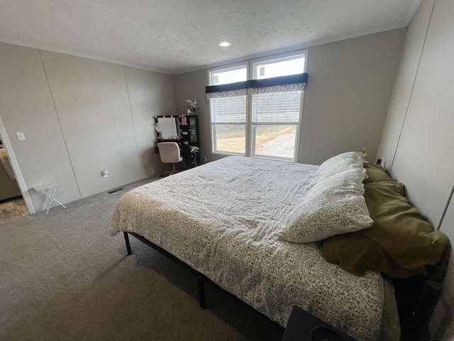 bedroom with a textured ceiling, carpet floors, and ornamental molding