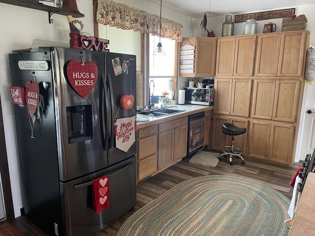 kitchen with beverage cooler, stainless steel fridge with ice dispenser, hanging light fixtures, light countertops, and a sink