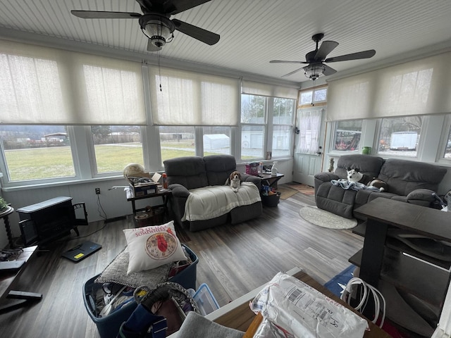 living room with wood finished floors and a ceiling fan