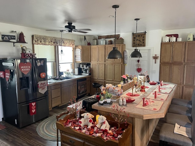 kitchen with wine cooler, stainless steel appliances, light countertops, dark wood finished floors, and pendant lighting