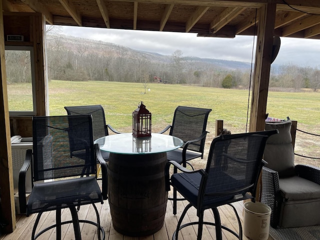 view of patio / terrace featuring outdoor dining space and a view of trees