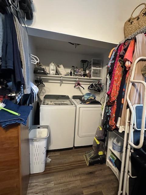 laundry room with dark wood-style floors and separate washer and dryer