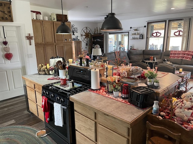 kitchen with a ceiling fan, gas stove, pendant lighting, and open floor plan