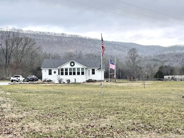 exterior space featuring a front lawn and a mountain view