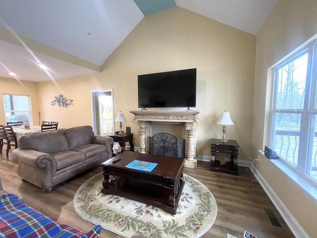 living room with high vaulted ceiling, dark wood-style flooring, a fireplace, visible vents, and baseboards