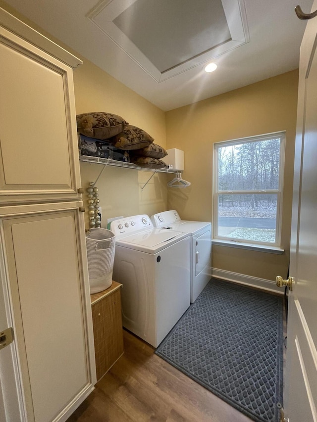 laundry room with washer and clothes dryer, recessed lighting, attic access, wood finished floors, and laundry area