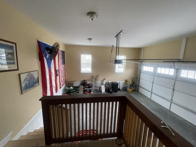 garage with a garage door opener and baseboards