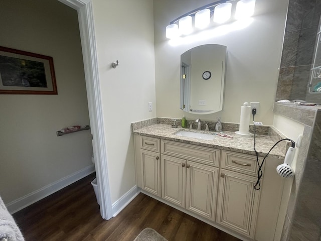 bathroom featuring baseboards, vanity, toilet, and wood finished floors