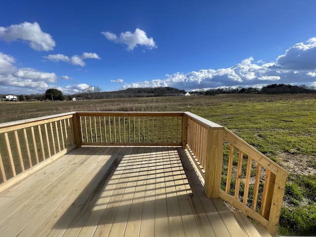 wooden deck with a rural view