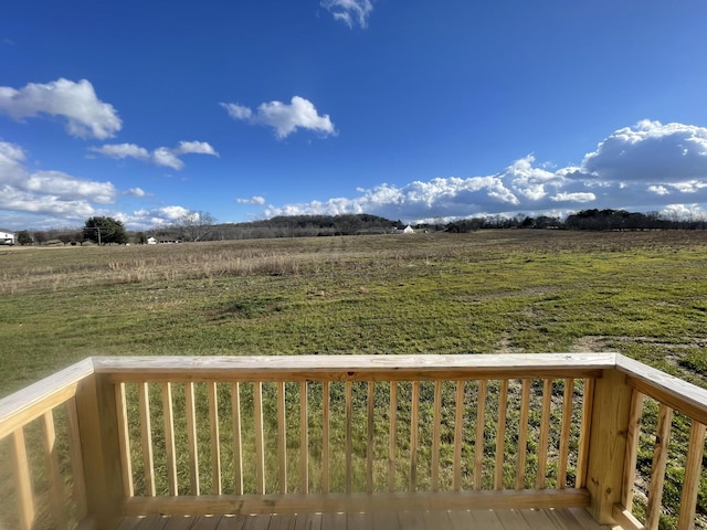 wooden terrace featuring a rural view