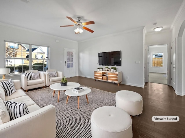 living area with dark wood finished floors, crown molding, and baseboards