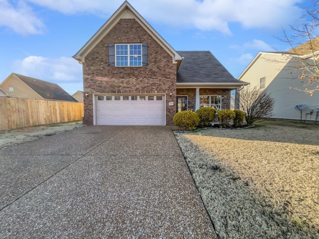 traditional home featuring concrete driveway, brick siding, fence, and an attached garage