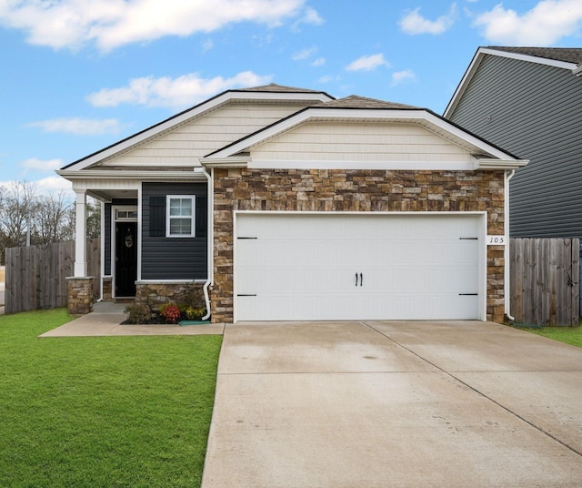 craftsman-style home with a garage, a front yard, stone siding, and fence