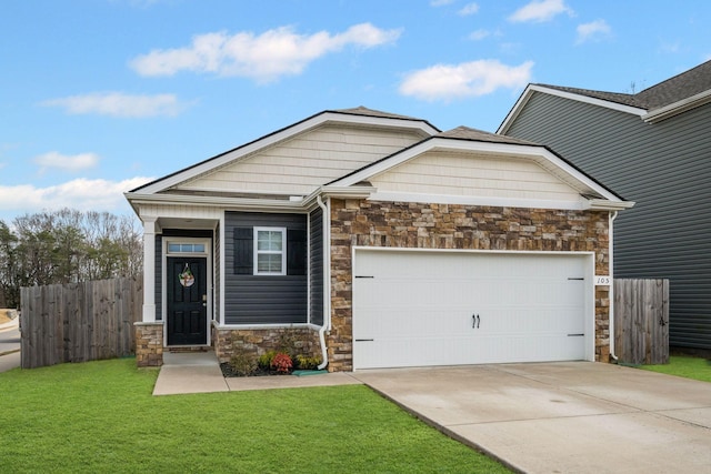 craftsman inspired home with a garage, stone siding, a front yard, and fence