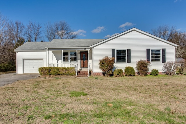 ranch-style home with a garage, a front lawn, and aphalt driveway