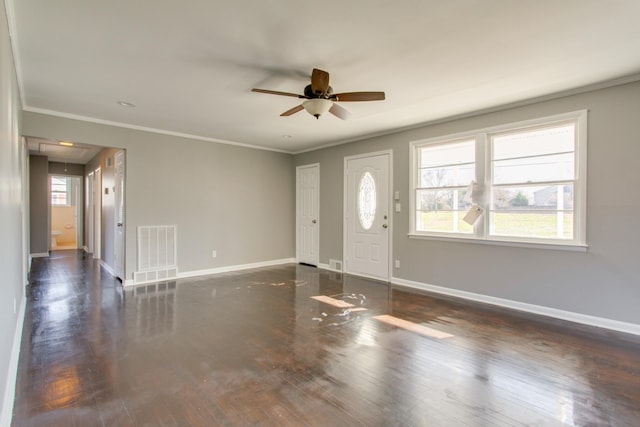 foyer with dark wood-style flooring, visible vents, crown molding, and baseboards