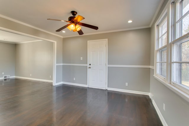 unfurnished room featuring a healthy amount of sunlight, baseboards, and crown molding