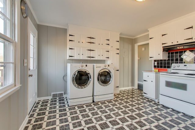 laundry area featuring dark floors, laundry area, visible vents, washer and dryer, and ornamental molding