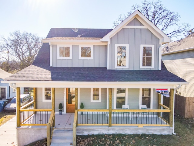 view of front of house featuring covered porch, a shingled roof, and board and batten siding