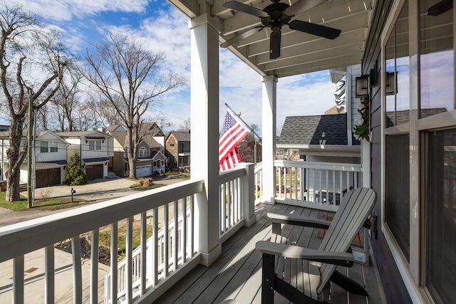 wooden terrace with a residential view and ceiling fan