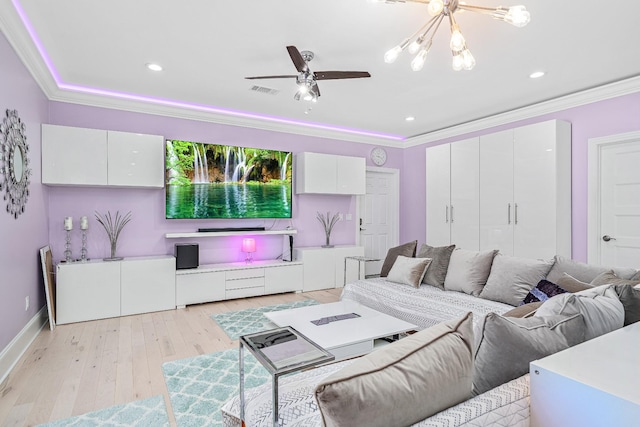 living room featuring light wood finished floors, a ceiling fan, and crown molding