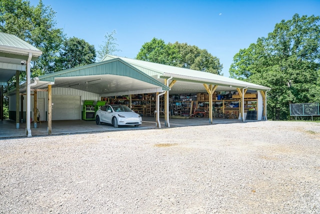 view of parking featuring a garage and a trampoline