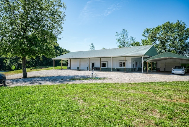 ranch-style home featuring metal roof, a carport, a front lawn, and gravel driveway