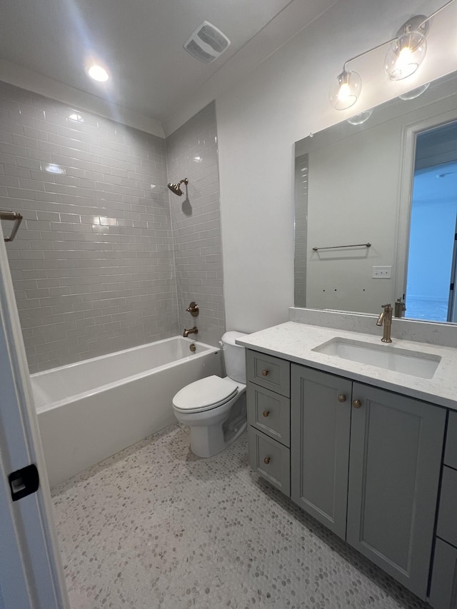 full bathroom featuring visible vents, vanity, toilet, and tub / shower combination