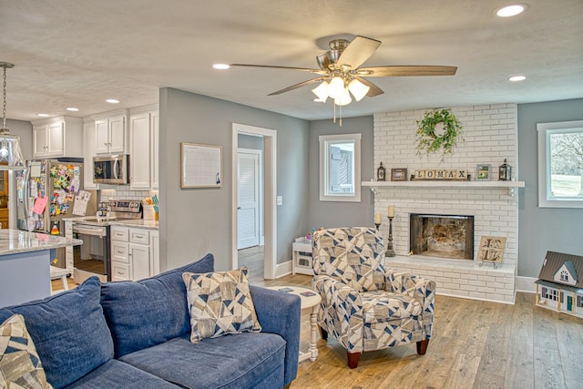 23 Hickman Hwy, Gordonsville, TN 38563 - living area featuring recessed lighting, a fireplace, light wood-style flooring, and baseboards