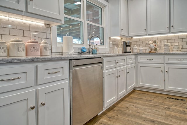 23 Hickman Hwy, Gordonsville, TN 38563 - kitchen with dishwasher, tasteful backsplash, light wood-type flooring, and white cabinets