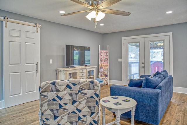 23 Hickman Hwy, Gordonsville, TN 38563 - living room with french doors, a barn door, wood finished floors, and baseboards