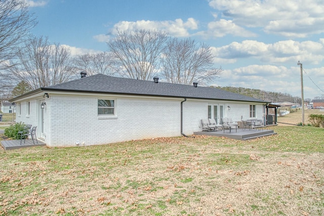 23 Hickman Hwy, Gordonsville, TN 38563 - rear view of house featuring brick siding, a lawn, and a patio area