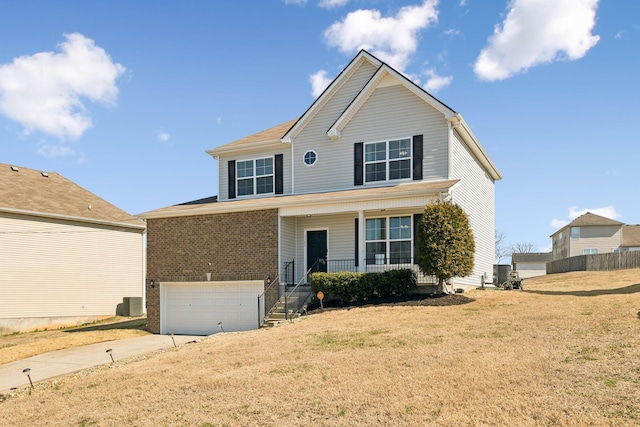 traditional-style house featuring brick siding, a porch, concrete driveway, an attached garage, and a front lawn