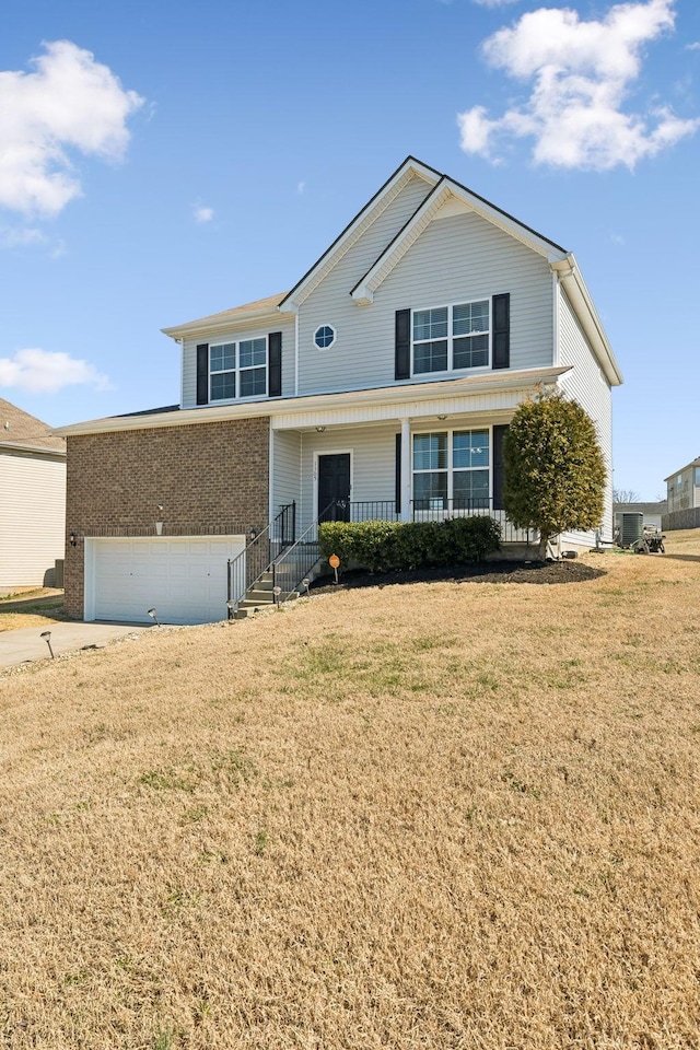 view of front of property featuring concrete driveway, brick siding, a porch, and a front yard