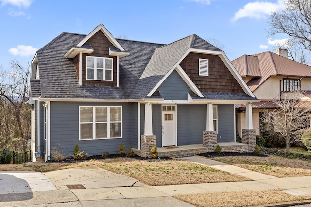 view of front of house with a shingled roof and covered porch