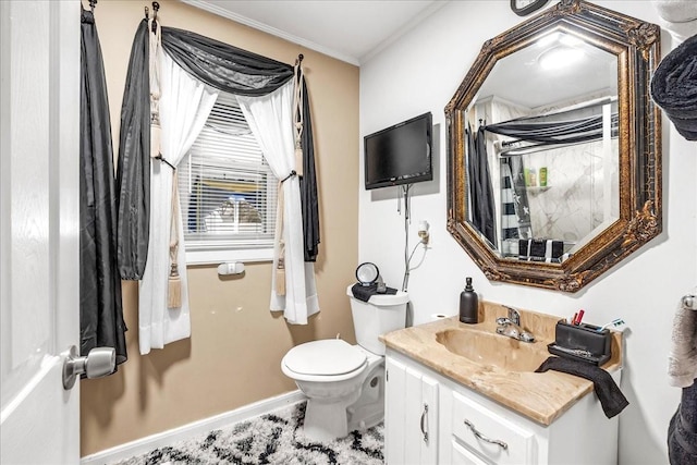 half bathroom featuring toilet, baseboards, ornamental molding, and vanity