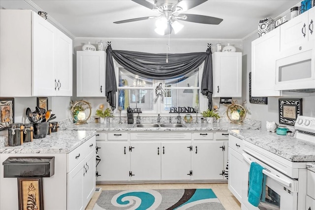 kitchen with white appliances, white cabinetry, and a sink