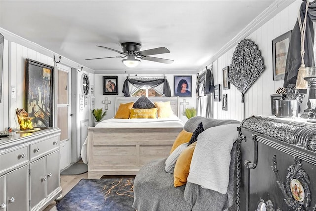 bedroom with ceiling fan, ornamental molding, and wood finished floors