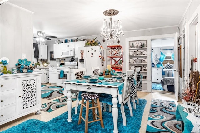 dining area with built in features, crown molding, and ceiling fan with notable chandelier