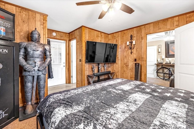 bedroom with ornamental molding, wood walls, and a ceiling fan