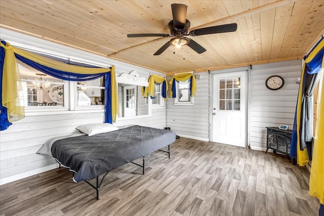 game room with a wood stove, wood ceiling, ceiling fan, and wood finished floors