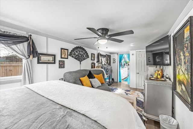 bedroom featuring a ceiling fan and crown molding