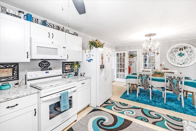 kitchen featuring light tile patterned floors, white appliances, light stone countertops, and white cabinets