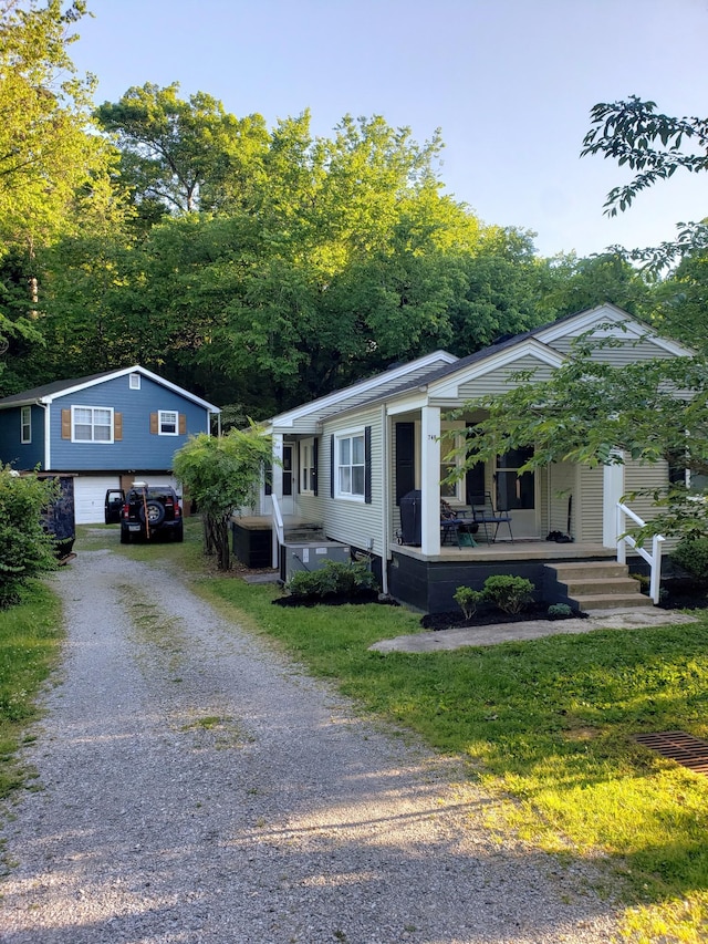 view of front of home with driveway and a porch