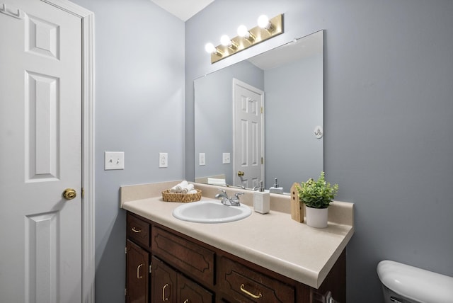 bathroom featuring toilet and vanity